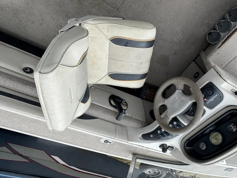 Slide: The Image of Interior of a 2000 Sylvan 1900 Excursion boat showing steering wheel and seat. - 8