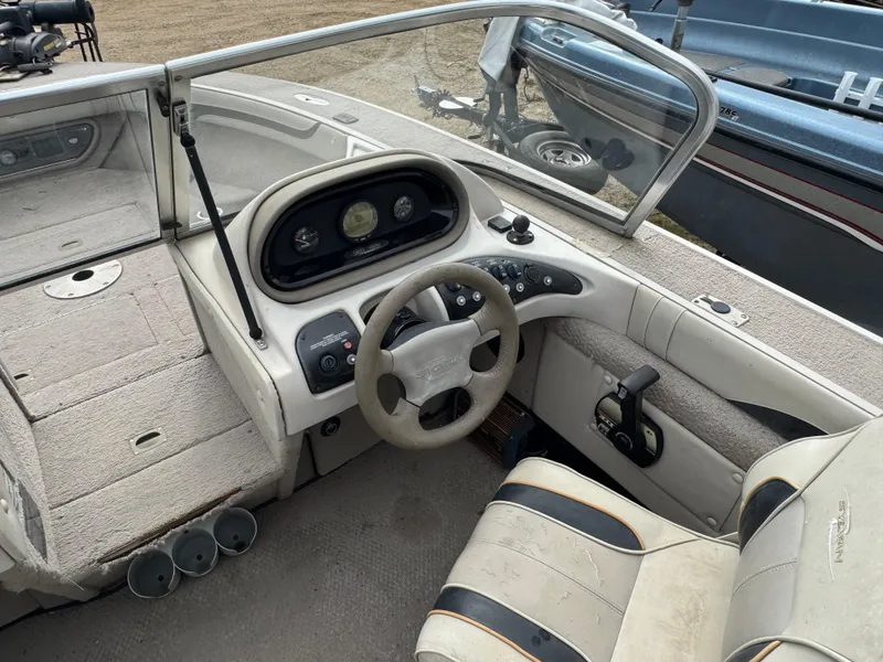 Slide: The Image of Interior of a 2000 Sylvan 1900 Excursion boat with steering wheel and dashboard controls. - 9
