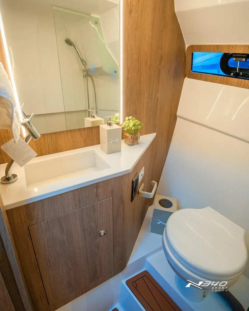 Slide: The Image of 2025 NX Boats NX340 Sport bathroom with modern design, wooden accents, and compact fixtures. - 6