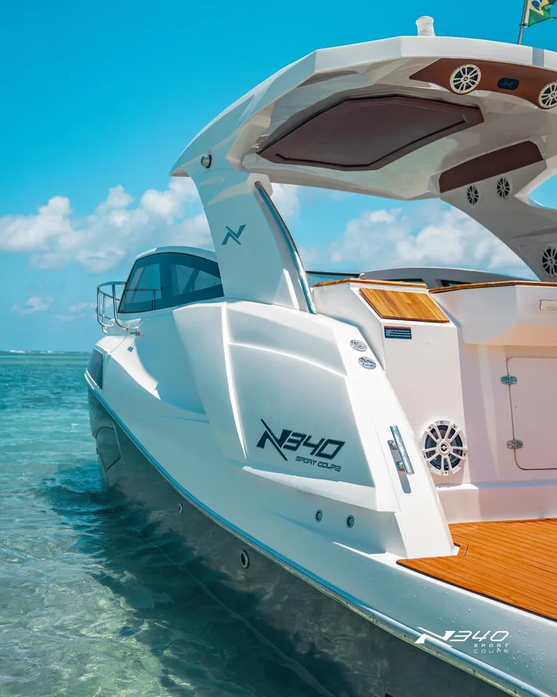 Slide: The Image of 2025 NX Boats NX340 Sport in clear blue waters, showcasing sleek design and luxury features. - 7