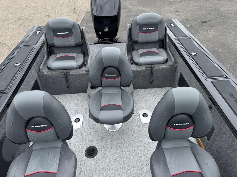 Slide: The Image of 2023 Tracker Targa V-18 WT boat interior with five gray seats and storage compartments. - 11