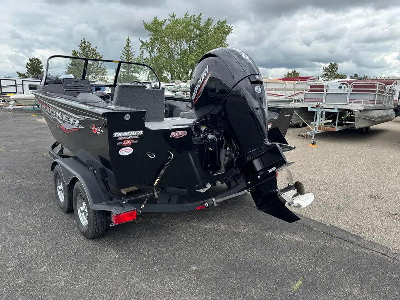 Slide: The Image of 2023 Tracker Targa V-18 WT boat with Mercury outboard motor, parked on a trailer. - 4