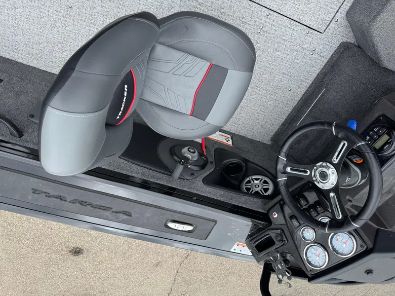 Slide: The Image of 2023 Tracker Targa V-18 WT boat interior with steering wheel and seat detail. - 6