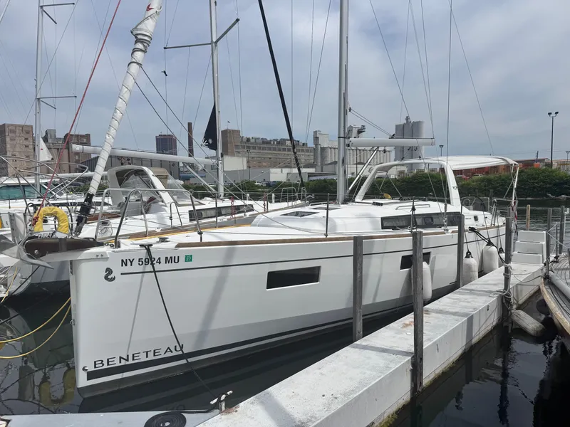 The Image of 2023 Beneteau Oceanis 38.1 sailboat for sale, displayed on a stand outdoors. - 0