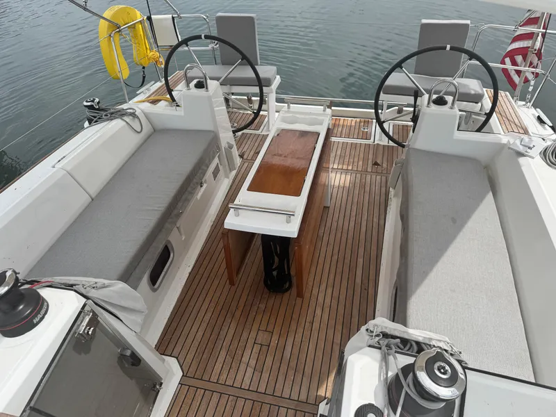 Slide: The Image of 2023 Beneteau Oceanis 38.1 sailboat bow at dock, featuring deck lines and railing. - 14