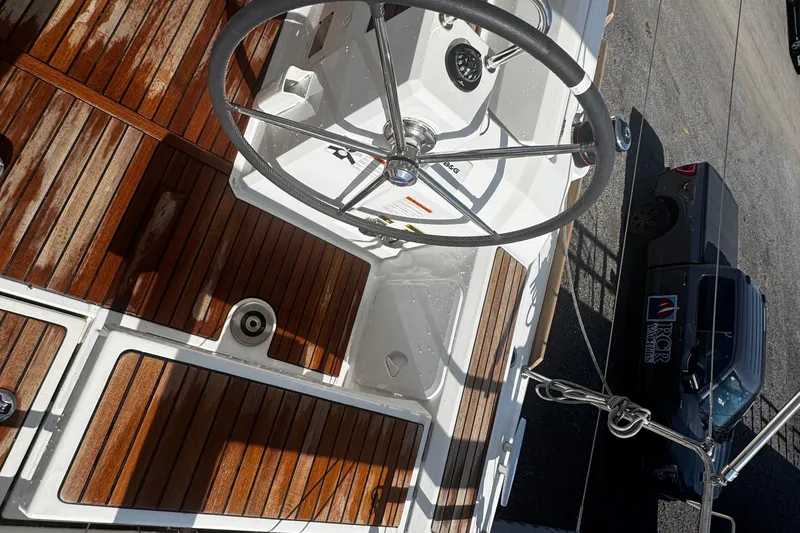 Slide: The Image of Cockpit of 2023 Beneteau Oceanis 38.1 with wooden table and seating area. - 35