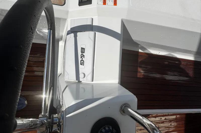 Slide: The Image of 2023 Beneteau Oceanis 38.1 yacht cockpit with wooden deck and steering wheel. - 36