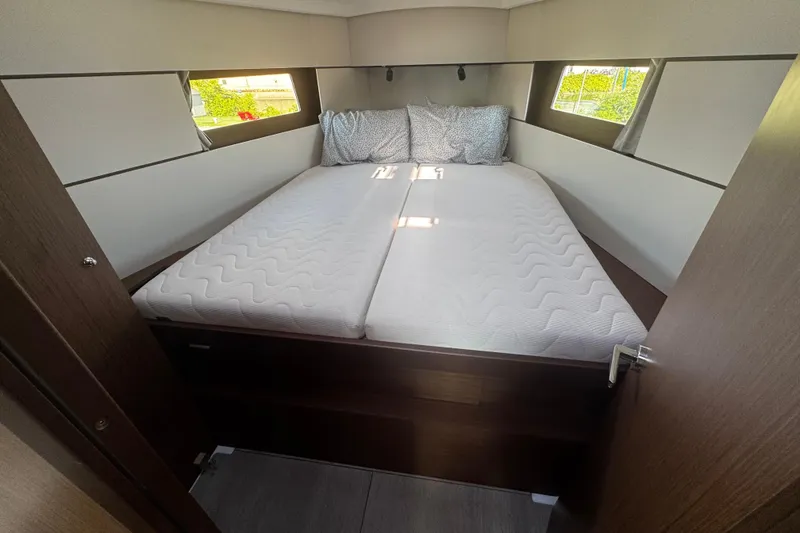 Slide: The Image of Interior view of 2023 Beneteau Oceanis 38.1 sailboat, featuring wiring and wooden paneling. - 40