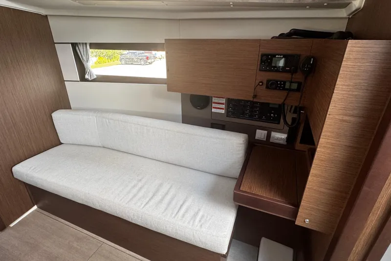 Slide: The Image of 2023 Beneteau Oceanis 38.1 interior with modern wood finish and comfortable seating. - 42
