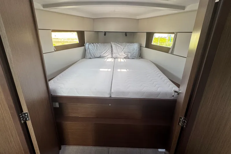 Slide: The Image of Interior of 2023 Beneteau Oceanis 38.1 yacht with wooden paneling and cushioned seating. - 43