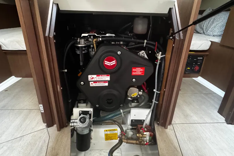 Slide: The Image of 2023 Beneteau Oceanis 38.1 yacht bathroom with sink and toilet, featuring wood paneling. - 49