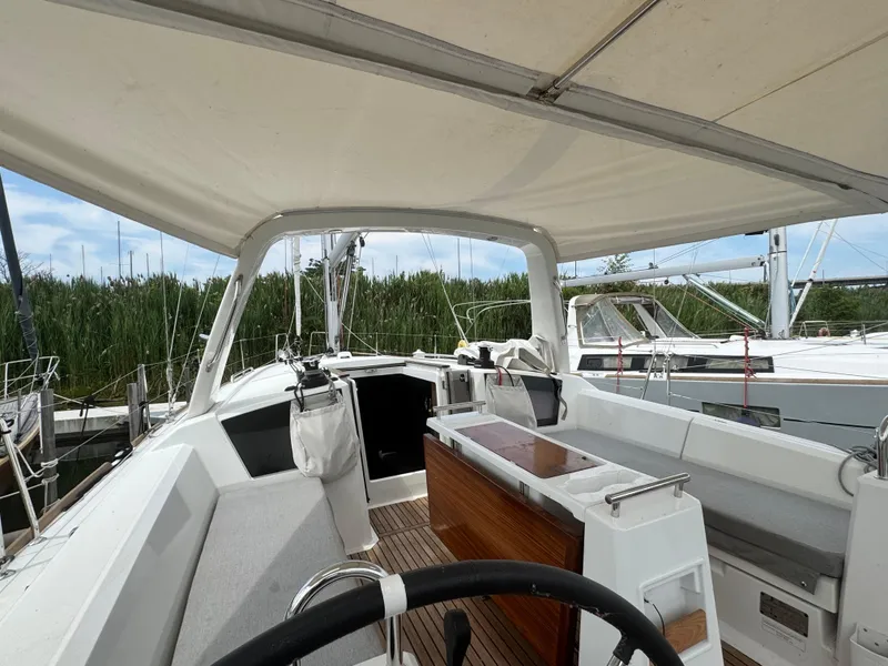 Slide: The Image of 2023 Beneteau Oceanis 38.1 yacht deck with wooden finish, docked at marina. - 9