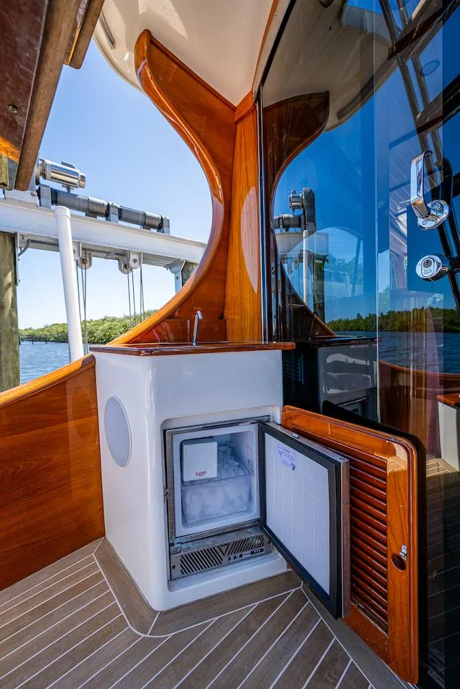 Slide: The Image of Hinckley Talaria 55 Flybridge MKII 2021 yacht with open mini fridge on deck. - 13