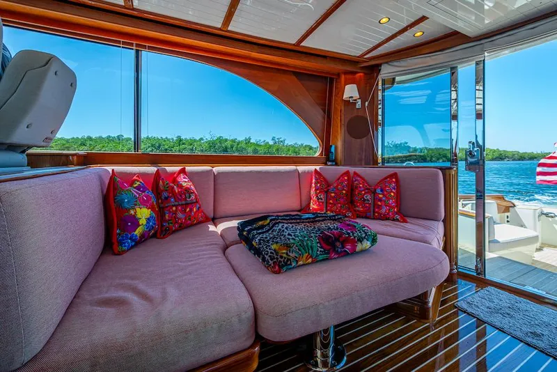 Slide: The Image of Luxurious interior of 2021 Hinckley Talaria 55 Flybridge MKII with plush seating and vibrant pillows. - 24