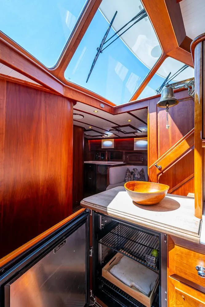 Slide: The Image of Luxurious interior of 2021 Hinckley Talaria 55 Flybridge MKII yacht with skylight and wooden finishes. - 26