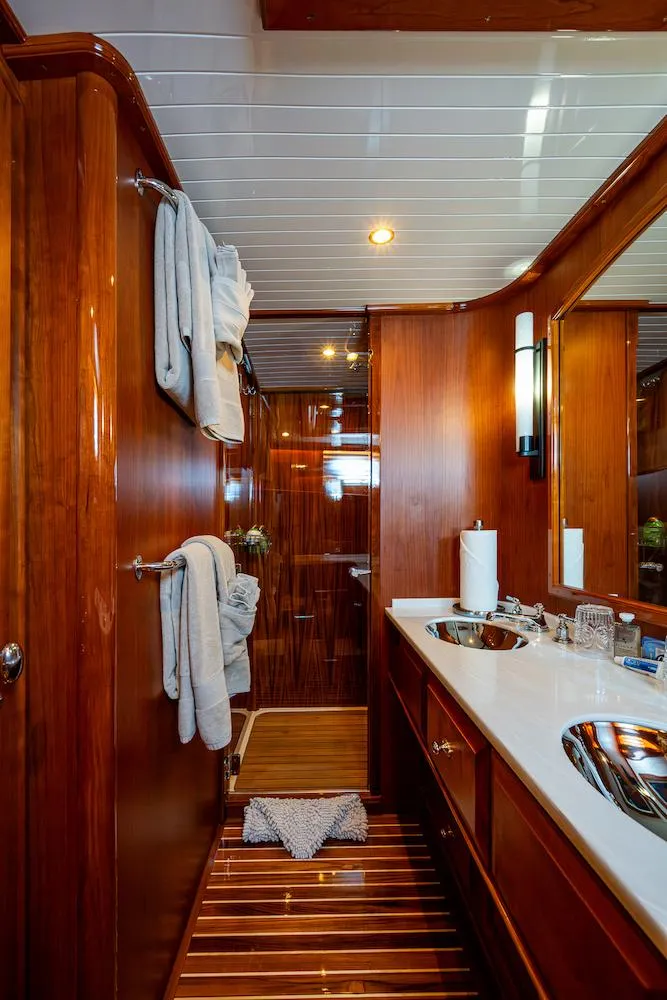Slide: The Image of Luxurious bathroom in 2021 Hinckley Talaria 55 Flybridge MKII yacht, featuring elegant wood finishes. - 34