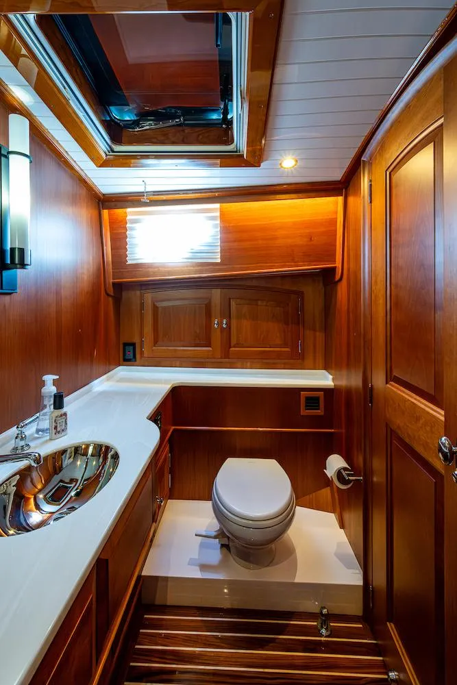 Slide: The Image of Luxurious 2021 Hinckley Talaria 55 Flybridge MKII yacht bathroom with wood accents and modern fixtures. - 36