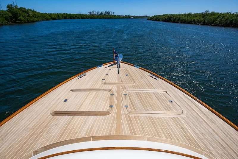 Slide: The Image of Hinckley Talaria 55 Flybridge MKII 2021 yacht cruising on a serene river. - 8