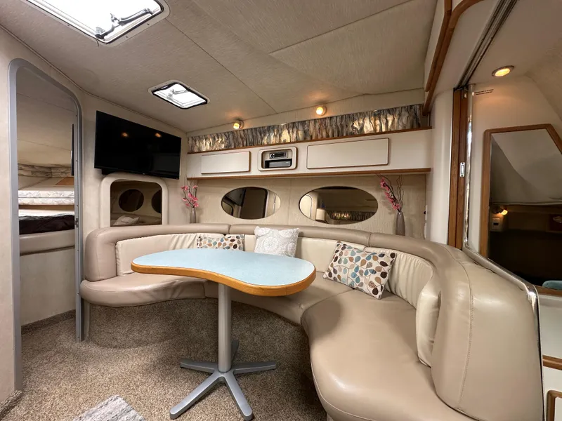 Slide: The Image of Interior of 1994 Sea Ray 370 Sundancer with cozy seating and modern amenities. - 11