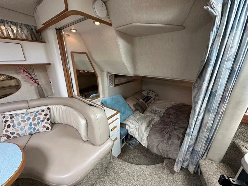 Slide: The Image of Interior of 1994 Sea Ray 370 Sundancer with cozy seating and sleeping area. - 12