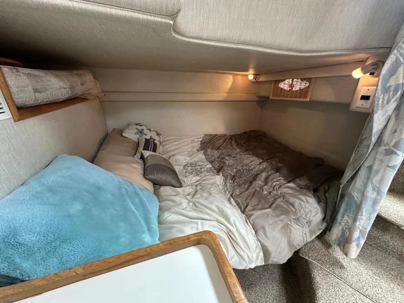 Slide: The Image of Cozy cabin interior of 1994 Sea Ray 370 Sundancer with bedding and soft lighting. - 13