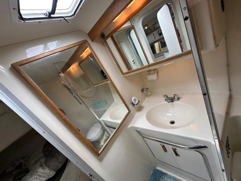 Slide: The Image of Bathroom interior of 1994 Sea Ray 370 Sundancer yacht, featuring sink and mirror. - 17