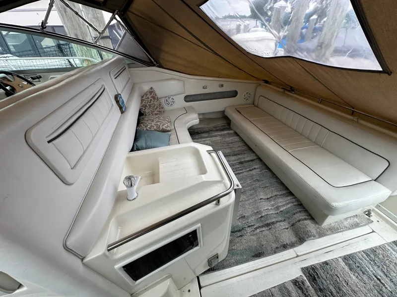 Slide: The Image of Interior of 1994 Sea Ray 370 Sundancer with white seating and carpeted floor. - 3