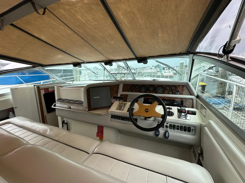Slide: The Image of Interior view of 1994 Sea Ray 370 Sundancer boat cockpit with steering wheel and controls. - 6