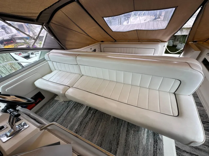 Slide: The Image of 1994 Sea Ray 370 Sundancer interior with white leather seating and helm station. - 7