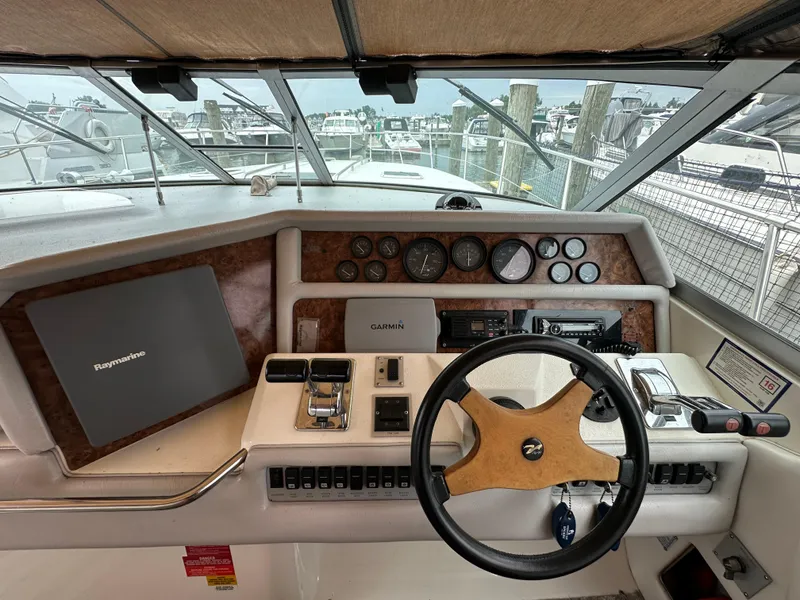 Slide: The Image of Cockpit of 1994 Sea Ray 370 Sundancer with steering wheel and navigation instruments. - 8
