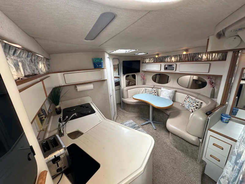Slide: The Image of Luxurious interior of 1994 Sea Ray 370 Sundancer yacht with kitchen and seating area. - 9
