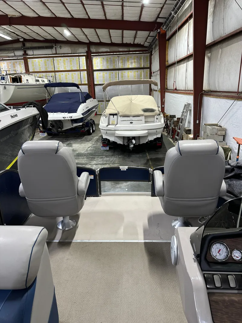 Slide: The Image of Interior view of a 2014 Premier 201 Explorer boat in a storage facility. - 10