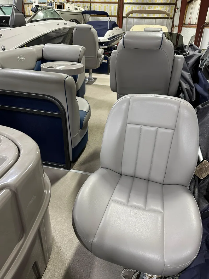 Slide: The Image of 2014 Premier 201 Explorer boat interior with gray seating and blue accents. - 12