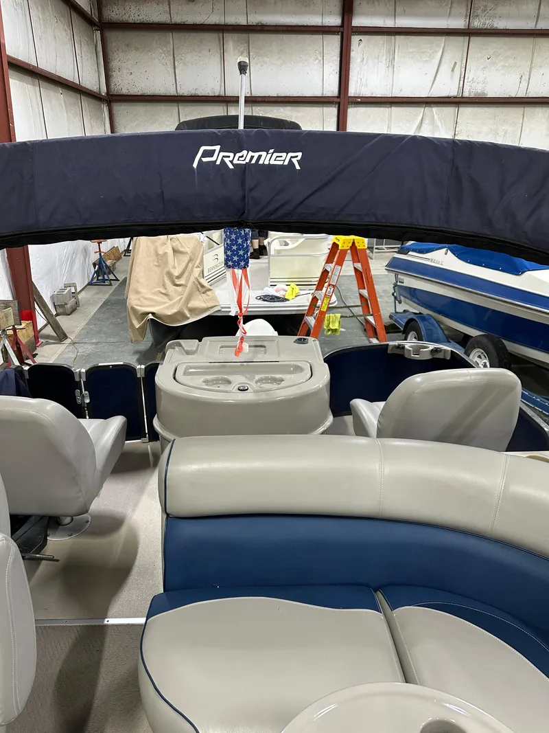Slide: The Image of 2014 Premier 201 Explorer pontoon boat interior in a warehouse setting. - 8