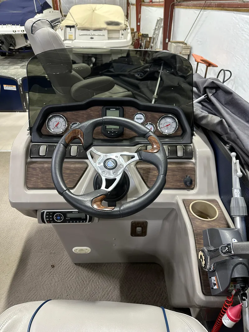 Slide: The Image of Steering console of a 2014 Premier 201 Explorer boat with gauges and controls. - 9