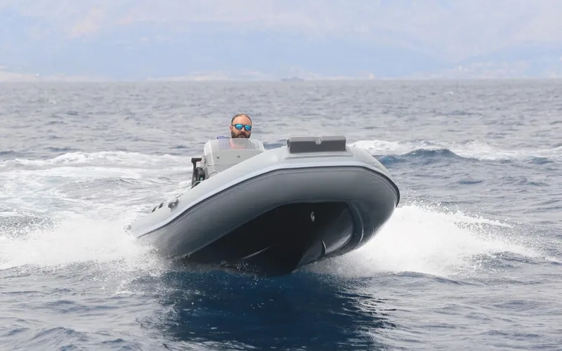 Slide: The Image of 2024 Northstar Axis 4.2 inflatable boat cruising on open water. - 2