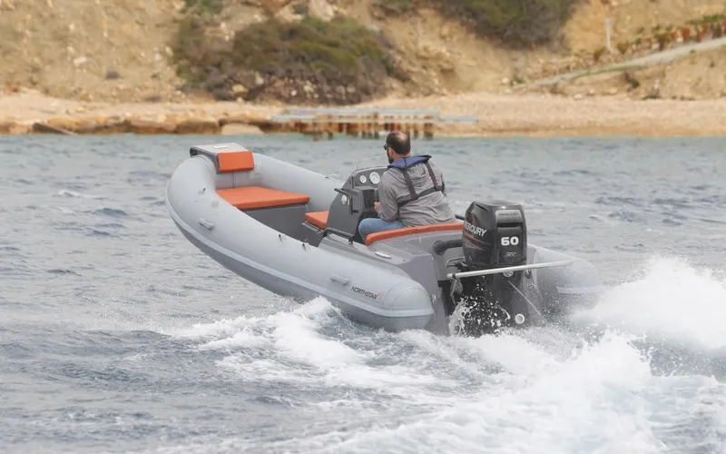 Slide: The Image of 2024 Northstar Axis 4.2 inflatable boat cruising on water. - 3