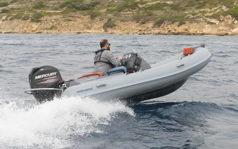 Slide: The Image of 2024 Northstar Axis 4.2 inflatable boat with Mercury outboard motor on the water. - 5