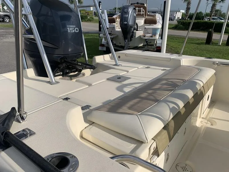 Slide: The Image of 2003 Scout 177 Sportfish boat interior with Yamaha 150 engine, featuring cushioned seating. - 10