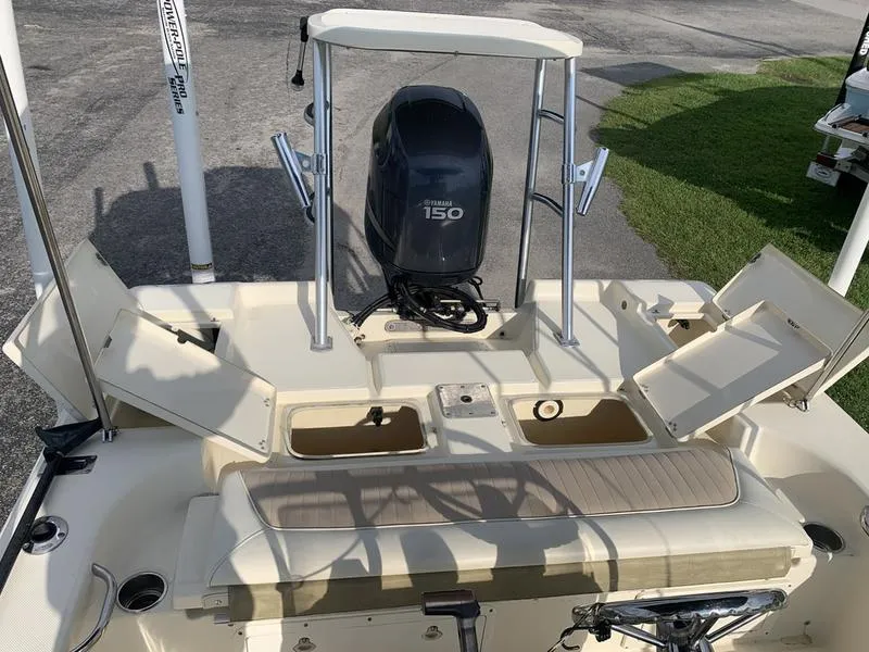 Slide: The Image of 2003 Scout 177 Sportfish boat with Yamaha 150 engine, open storage compartments. - 11