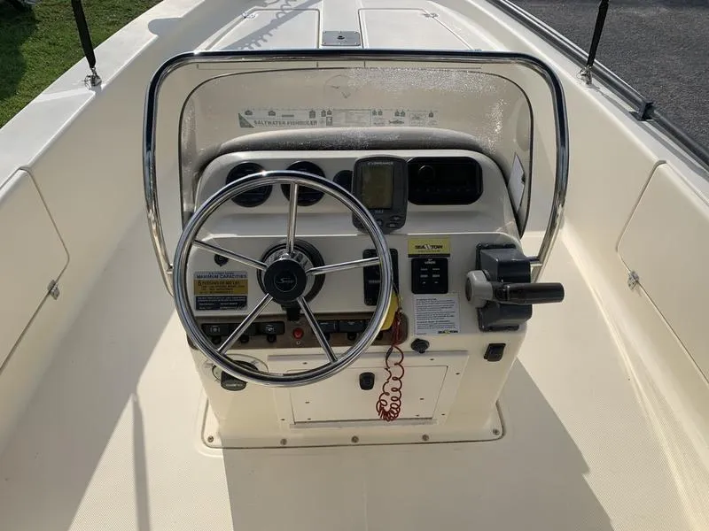 Slide: The Image of 2003 Scout 177 Sportfish boat console with steering wheel and controls. - 13