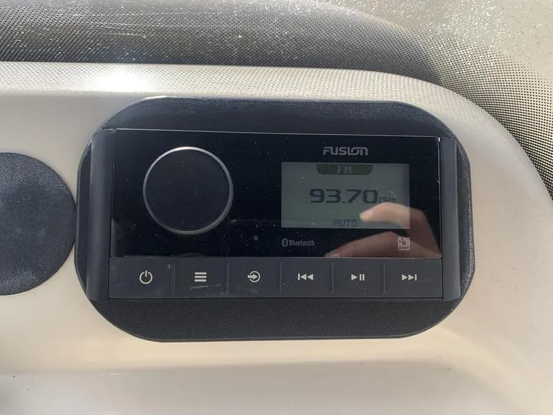 Slide: The Image of Fusion marine stereo displaying FM 93.70 MHz on a 2003 Scout 177 Sportfish boat. - 14