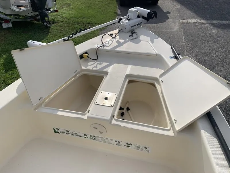 Slide: The Image of 2003 Scout 177 Sportfish boat with open storage compartments and trolling motor. - 18