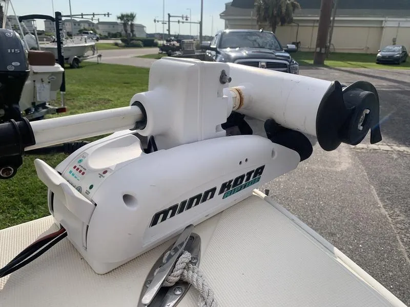 Slide: The Image of Minn Kota trolling motor on 2003 Scout 177 Sportfish boat, parked outdoors. - 21