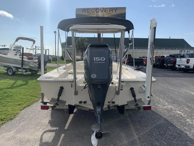 Slide: The Image of 2003 Scout 177 Sportfish boat with 150 horsepower engine, parked outdoors. - 3