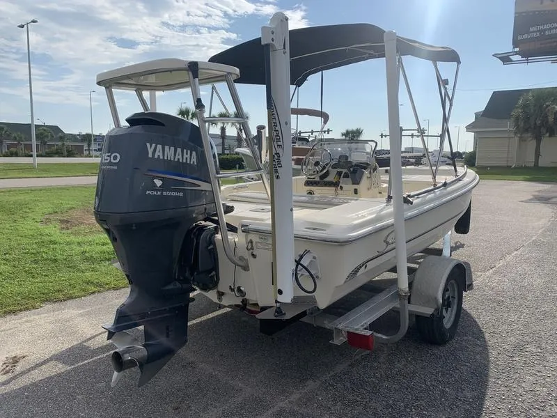 Slide: The Image of 2003 Scout 177 Sportfish boat with Yamaha 150 engine on trailer, parked outdoors. - 4
