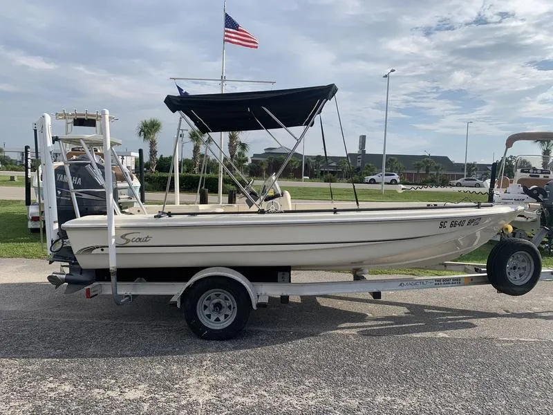 Slide: The Image of 2003 Scout 177 Sportfish boat on trailer with canopy, parked outdoors. - 5