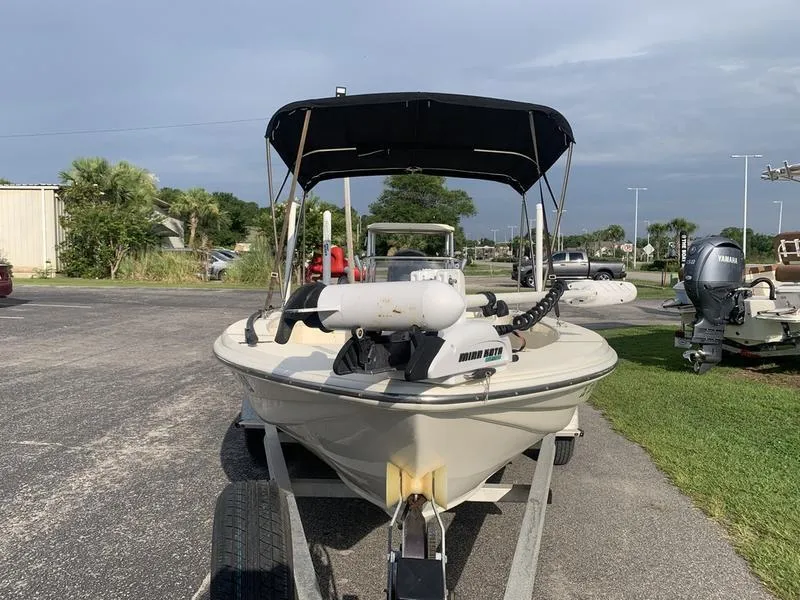 Slide: The Image of 2003 Scout 177 Sportfish boat on trailer with canopy, parked outdoors. - 7