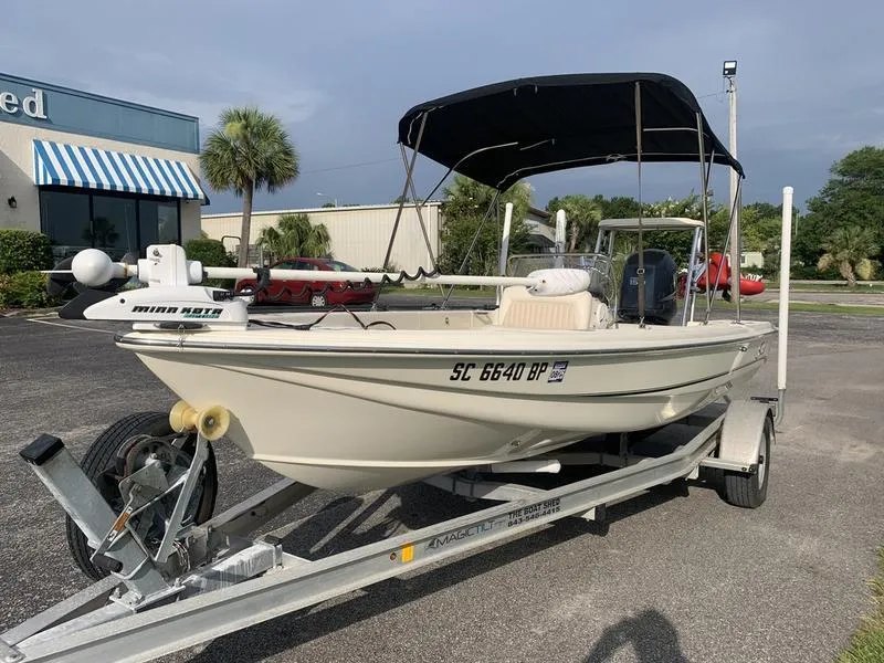Slide: The Image of 2003 Scout 177 Sportfish boat on trailer with canopy, parked outdoors. - 8