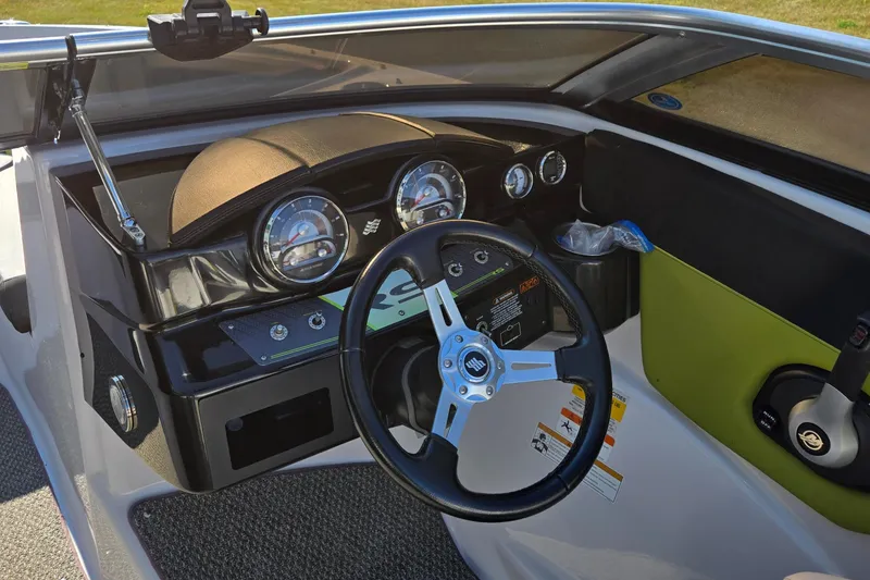 Slide: The Image of 2013 Four Winns H190RS boat dashboard with steering wheel and gauges. - 10